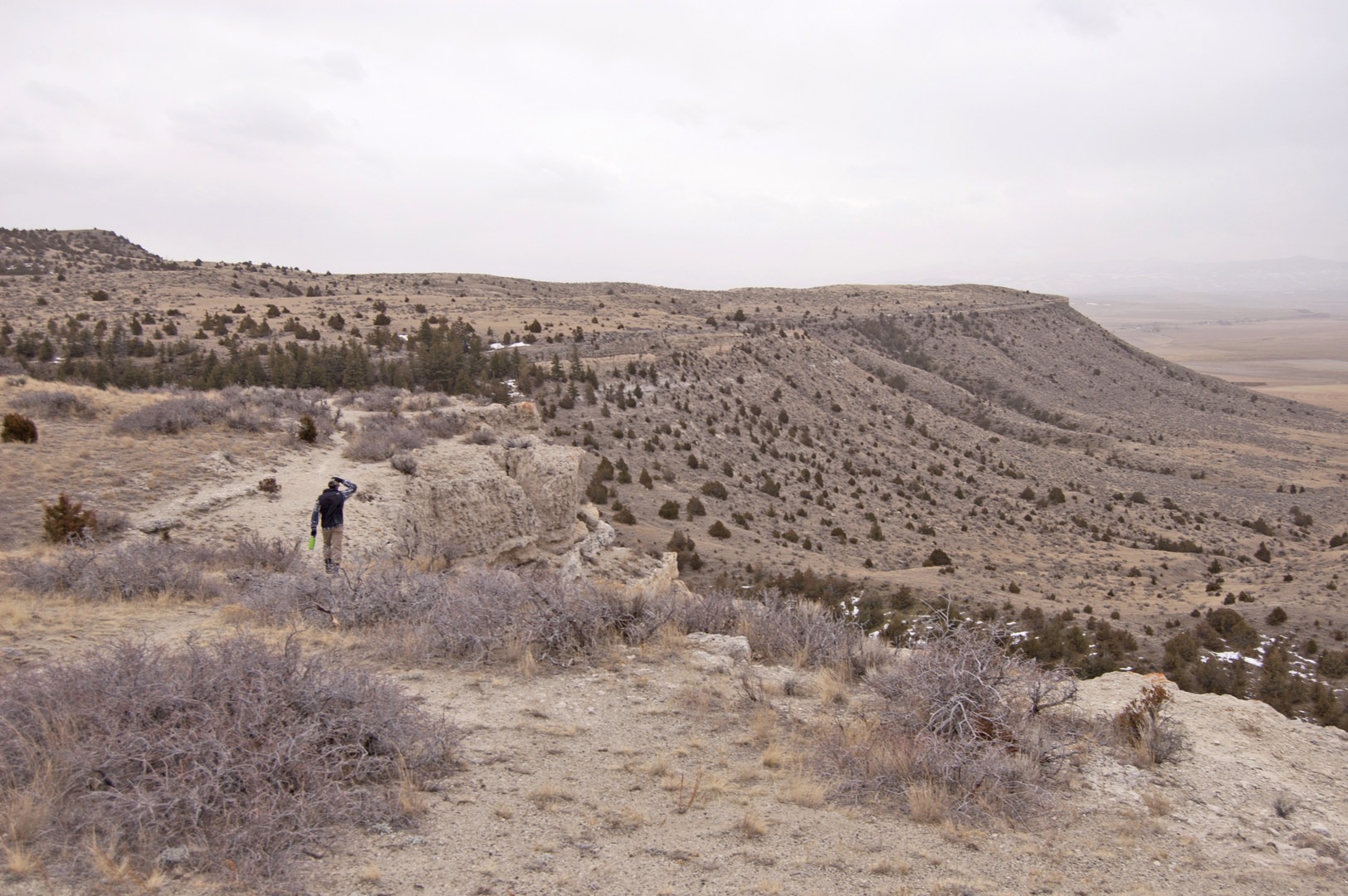 A trail winds along the edge of the cliff.