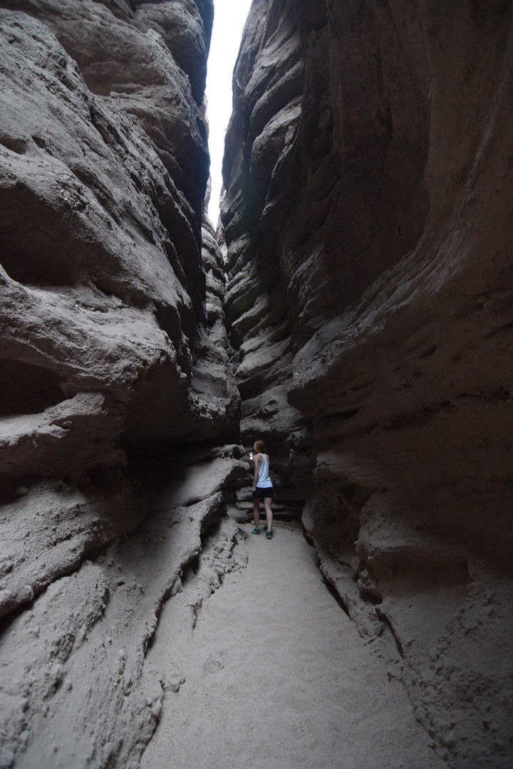 The sedimentary rock of the slot canyon gets torn away by rushing water.