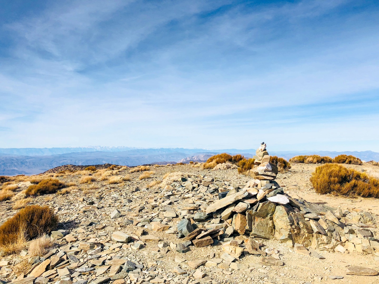 Progress past the false peak for another quarter-mile until you reach the peak, marked by a single large cairn.
