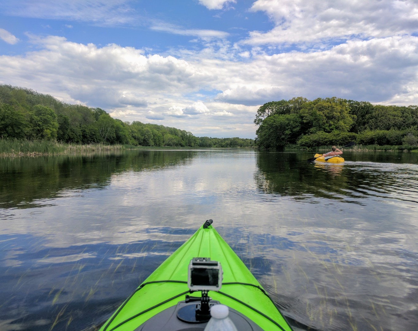 A couple of kayaks on a beautiful spring day following the current of the Ottertail River.