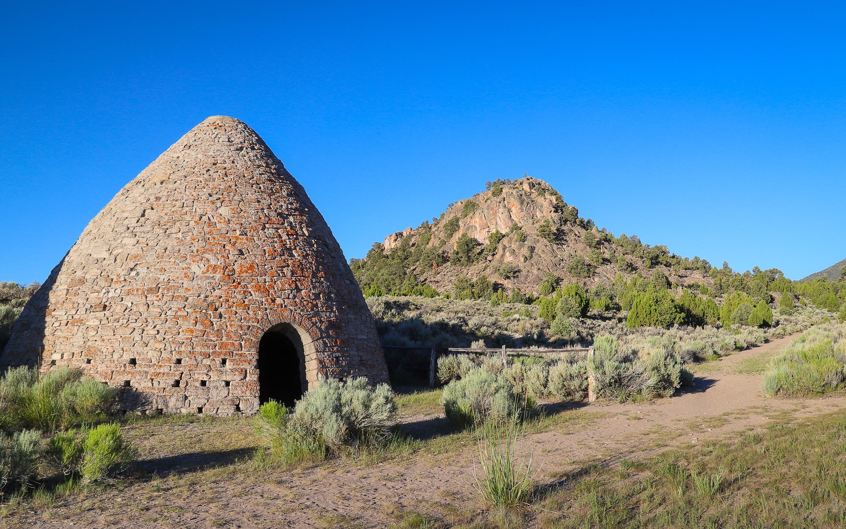 One of the large charcoal ovens with Rocky Point in the background.