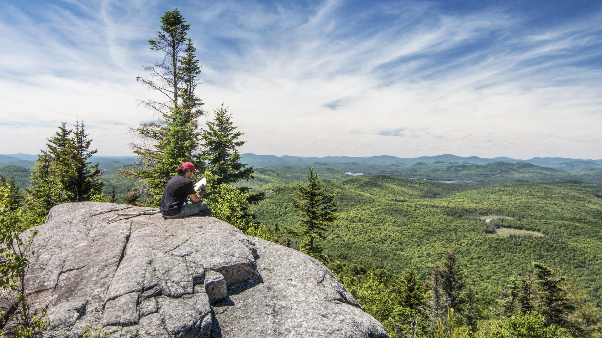 Studying a map while taking in the peak views.