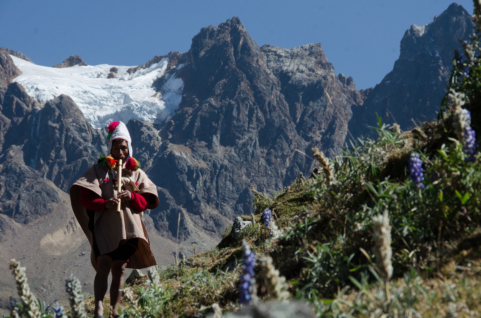 A local traditional Incan priest conducts a ceremony heading up to a lake near Salkantay Pass.
