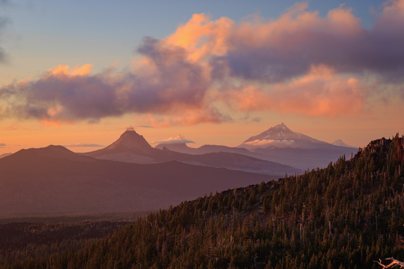Colorful sunset over (from the left) Mount Washington, Three Fingered Jack, Mount Jefferson, and Mount Hood.