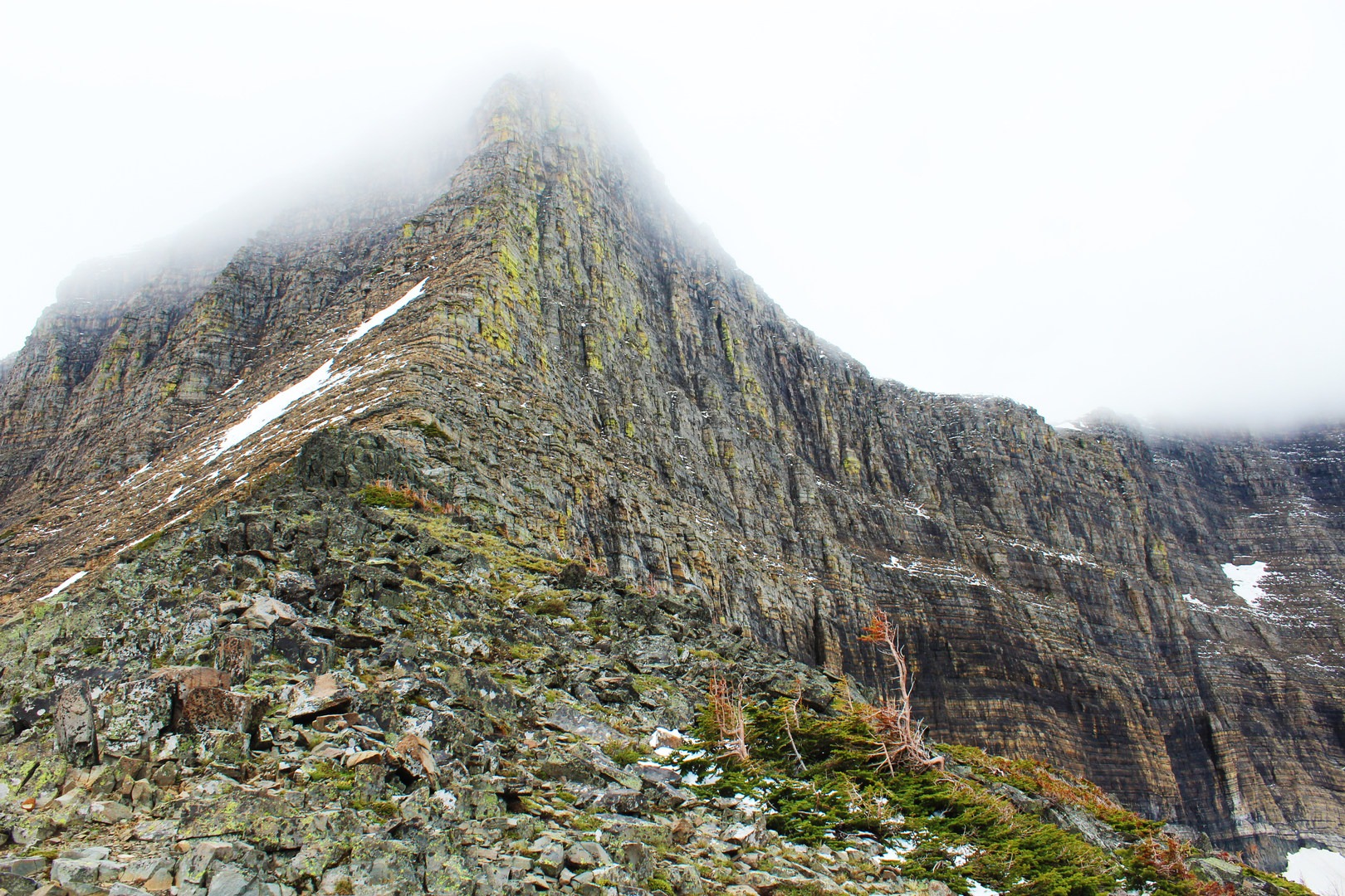 The imposing wall of Triple Divide Peak as seen from the pass. Many hikers stop here at the pass or continue on over it to St. Mary Lake on the west side of the park.