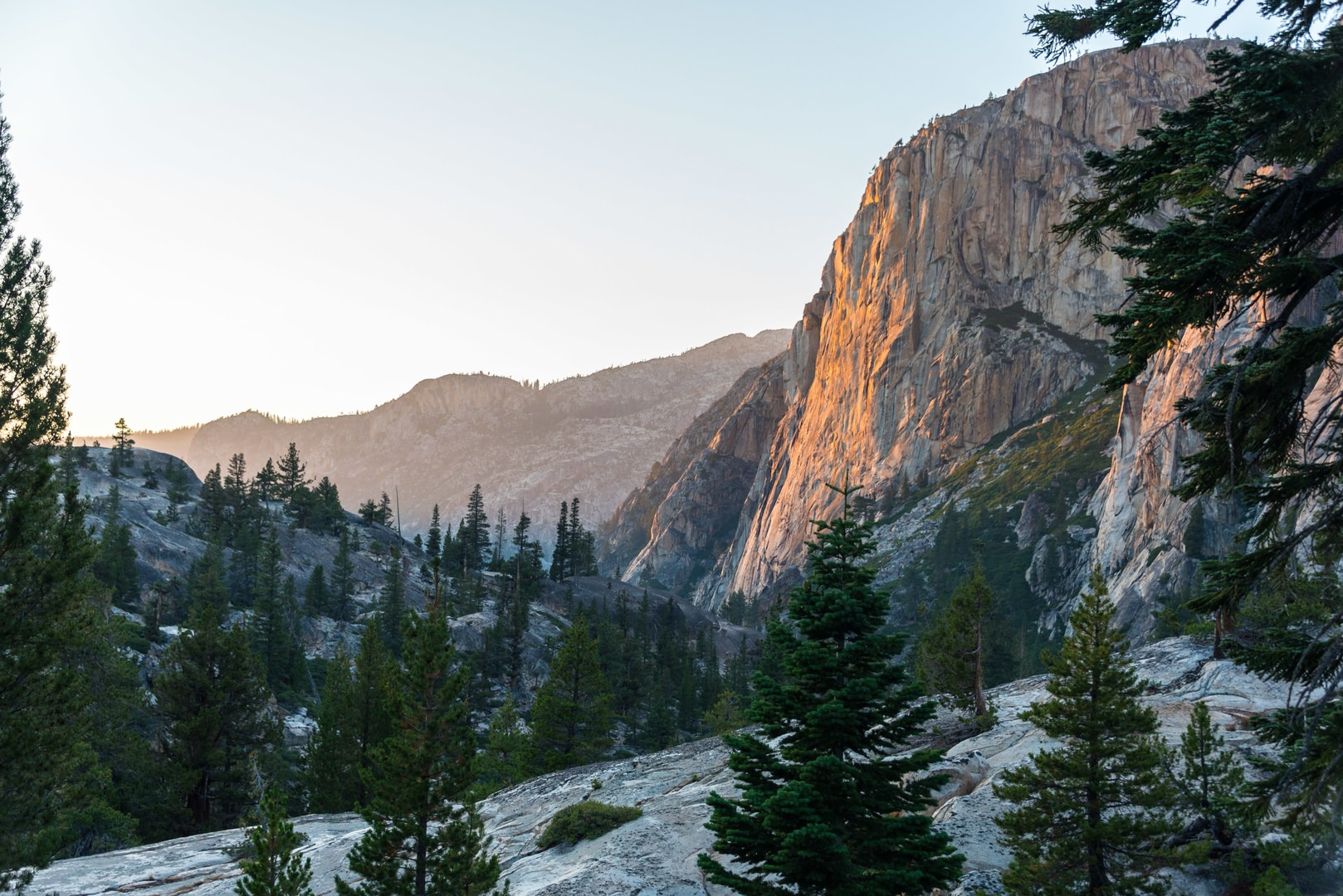 The last rays of light casting a fiery glow on the granite cliffs.