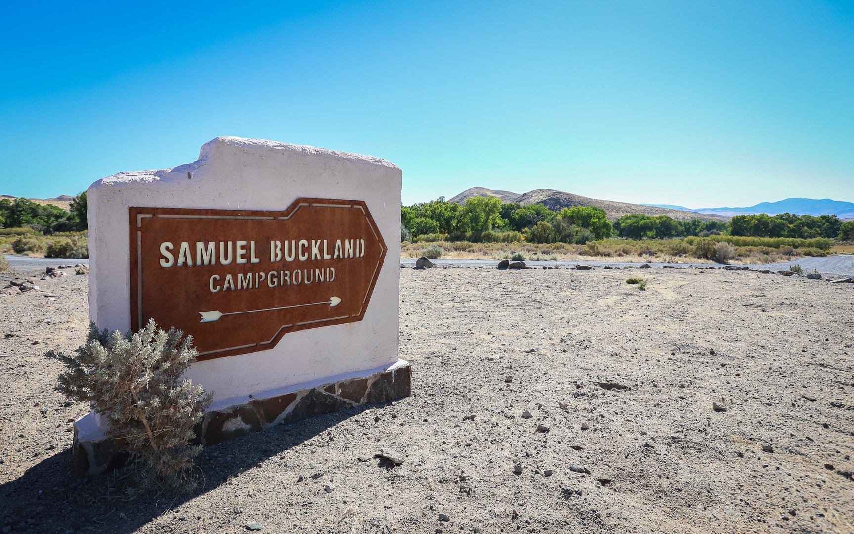 Sign pointing toward Samuel Buckland Campground along the the main loop road in Fort Churchill State Historic Park.