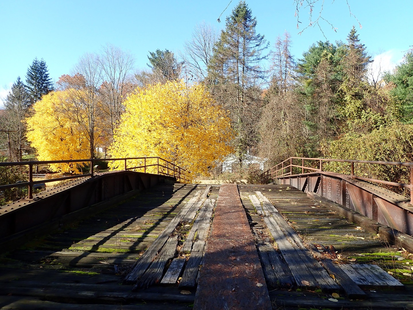 Crossing an abandoned bridge to access the trail.