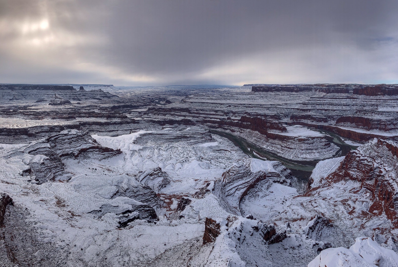 The Colorado River below with a winter storm in the distance.