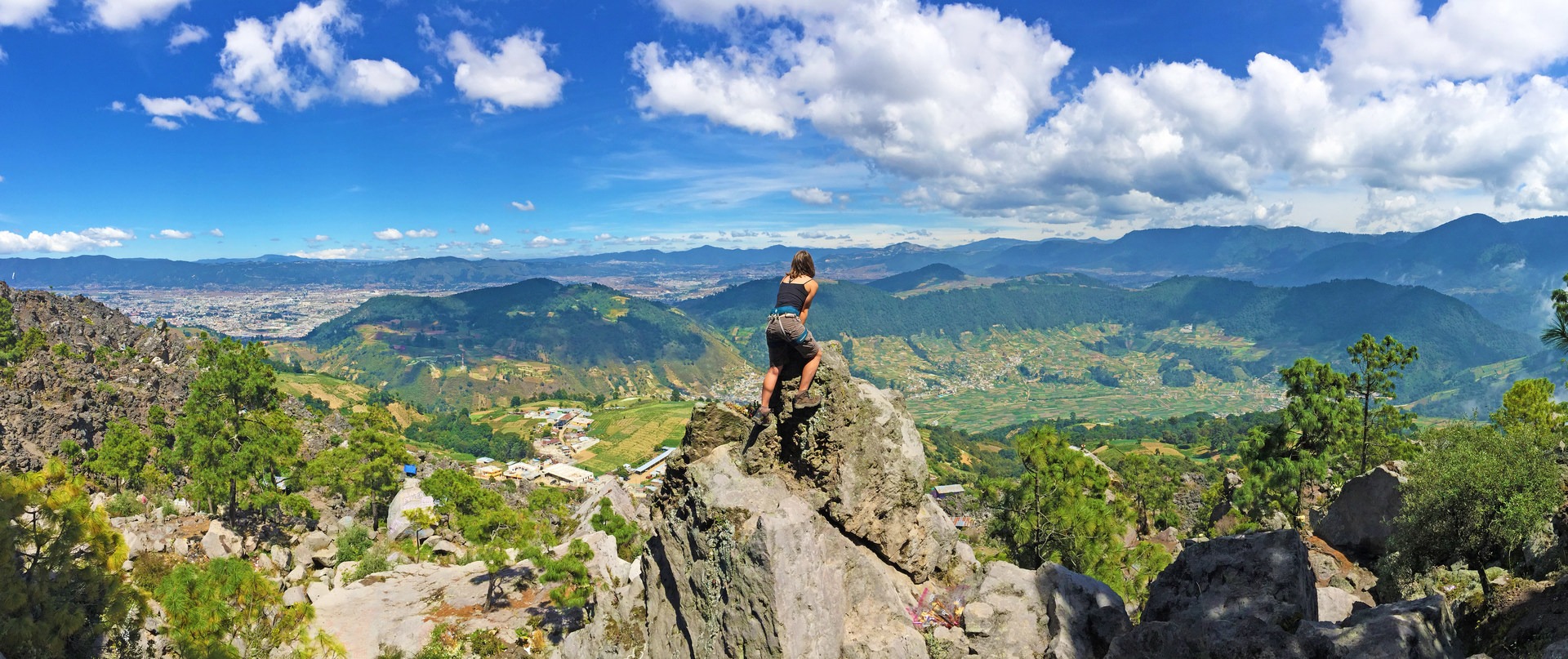 Amber McDaniel (adventure contributor) overlooking the stunning valley below with Canton Chicuá, nearest to the bottom, and the sprawling city of Xela in the distance.