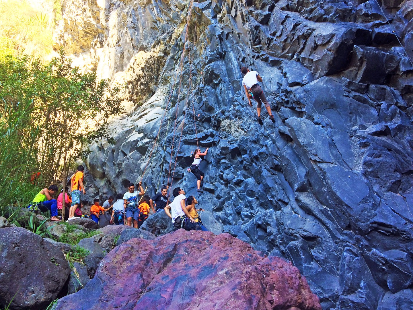 A mix of local climbers out for an after work send sesh and tourists on a guided trip. Both groups are climbing and cheering each other on, a typical environment of the friendly and close-quarters crag.