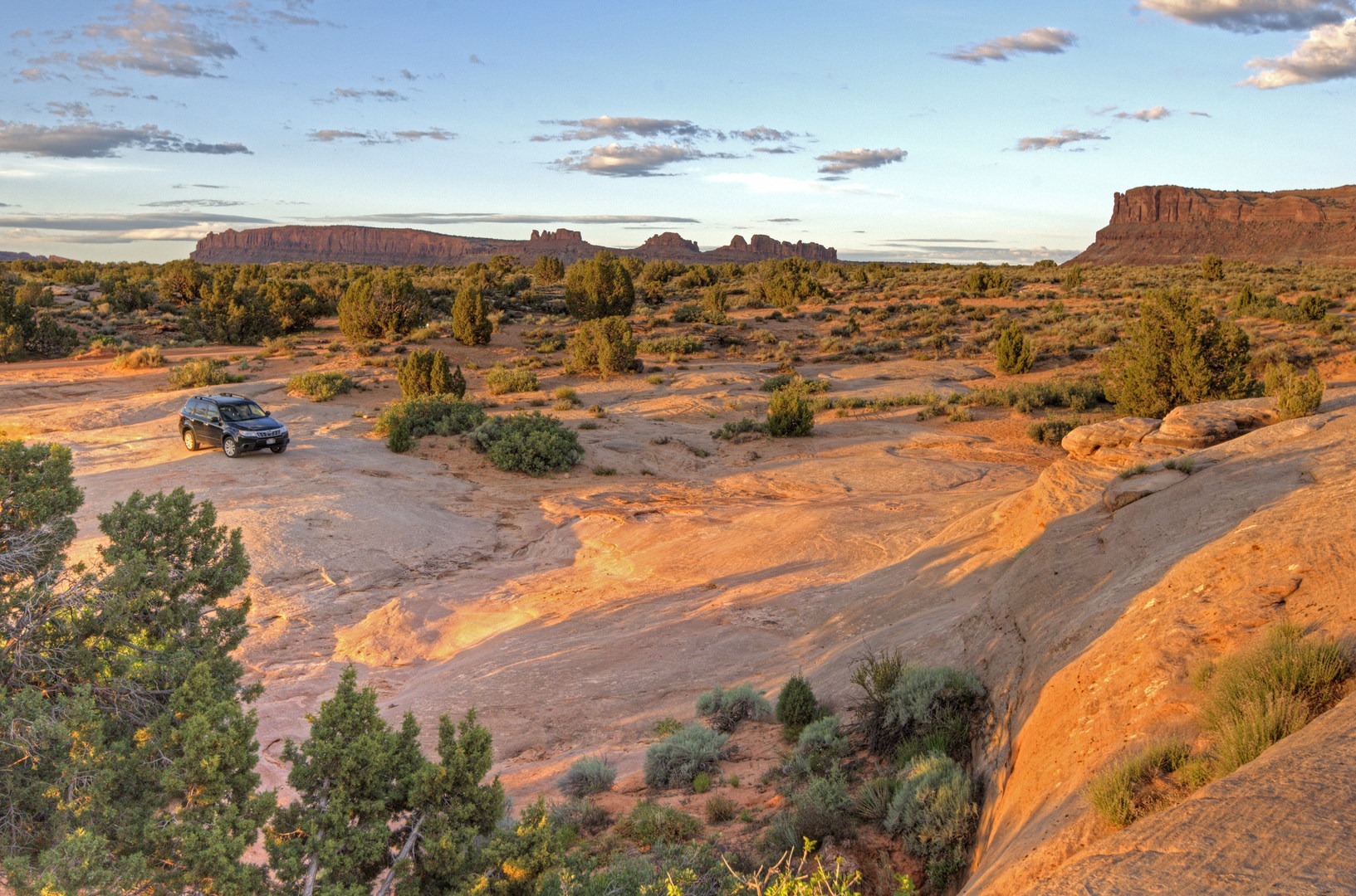 The white Navajo sandstone makes for a great place to park your RV or to put up a tent.