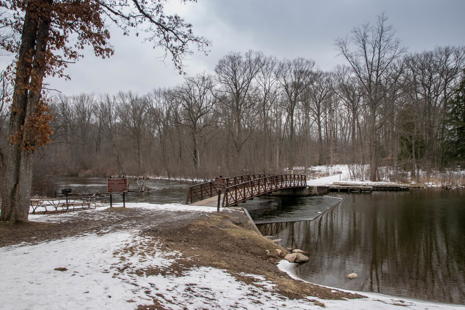 Bridge crossing the Huron River with more trails to the East. This is a popular trout fishing locale in the spring.