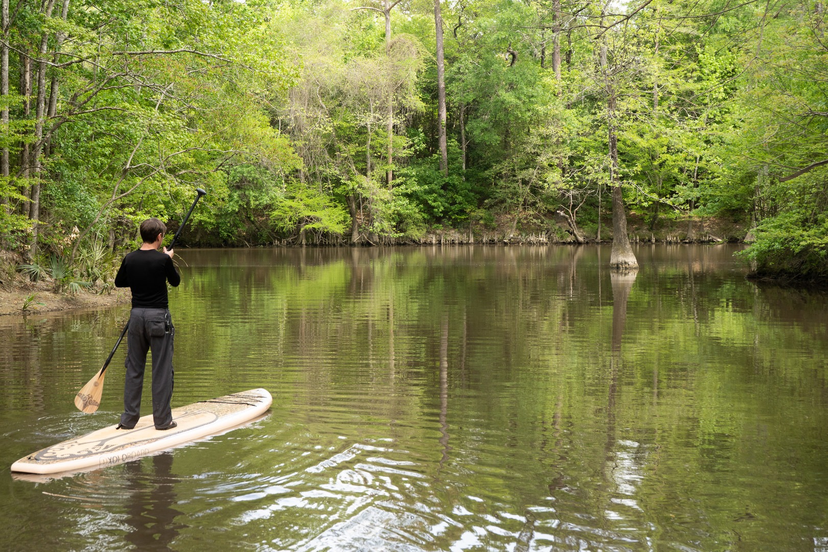 Paddleboarder enjoying a stretch of water on the Calcasieu River.