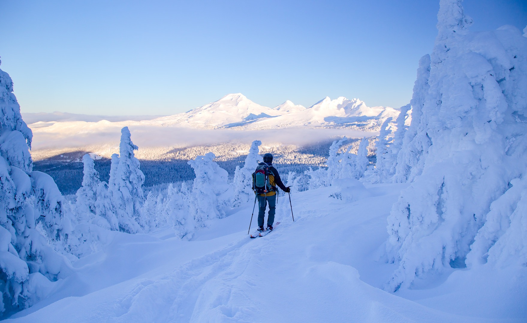 Skinning up Tumalo Mountain with the Three Sisters and Broken top above.