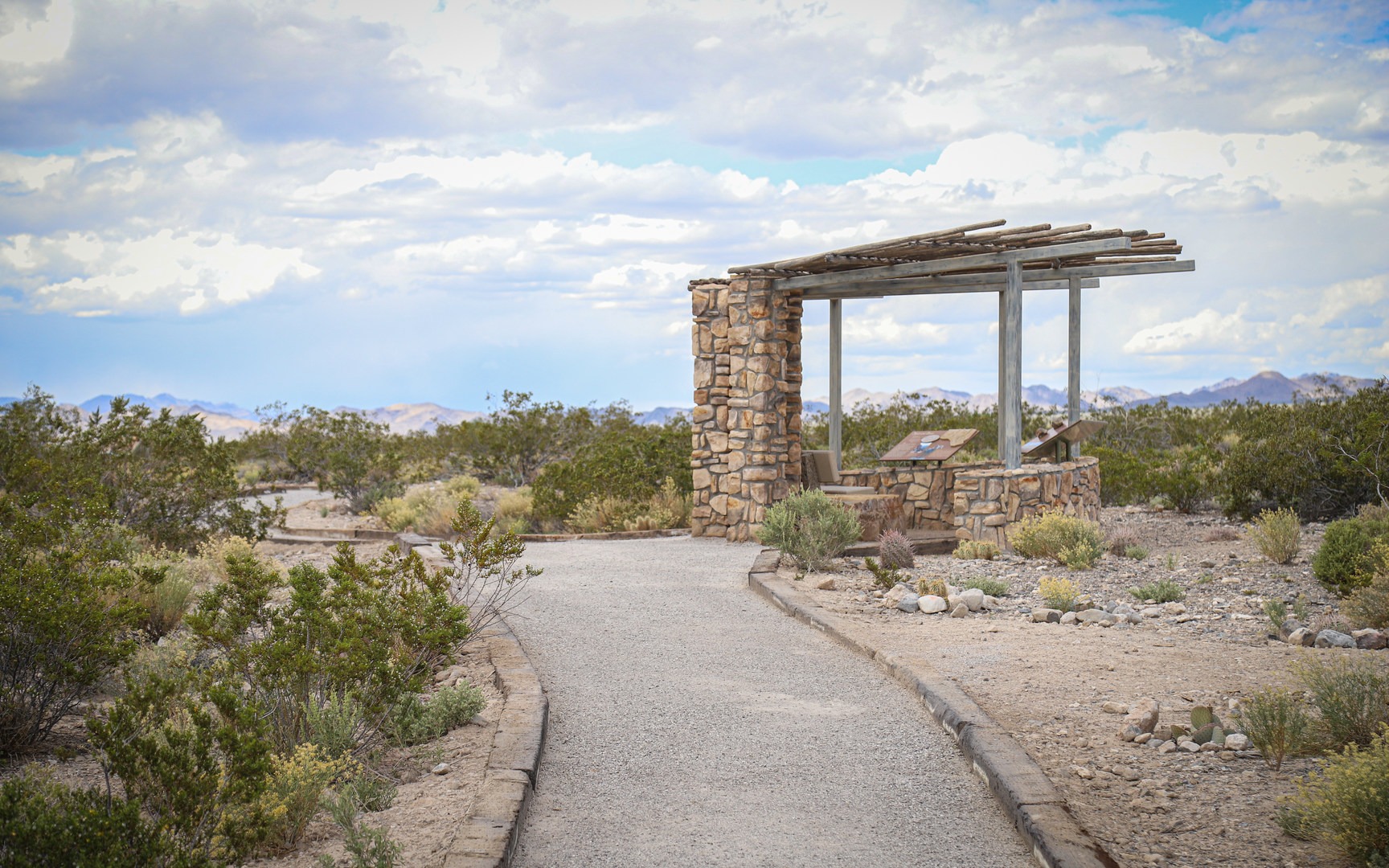 A shade structure offers views of the mountains deeper in the wildlife refuge.