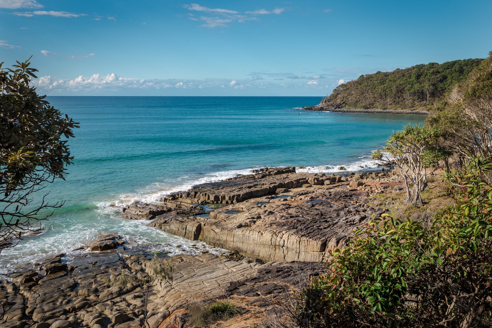 Exploring the beautiful coves that line Noosa National Park with Dolphin Point in the background.