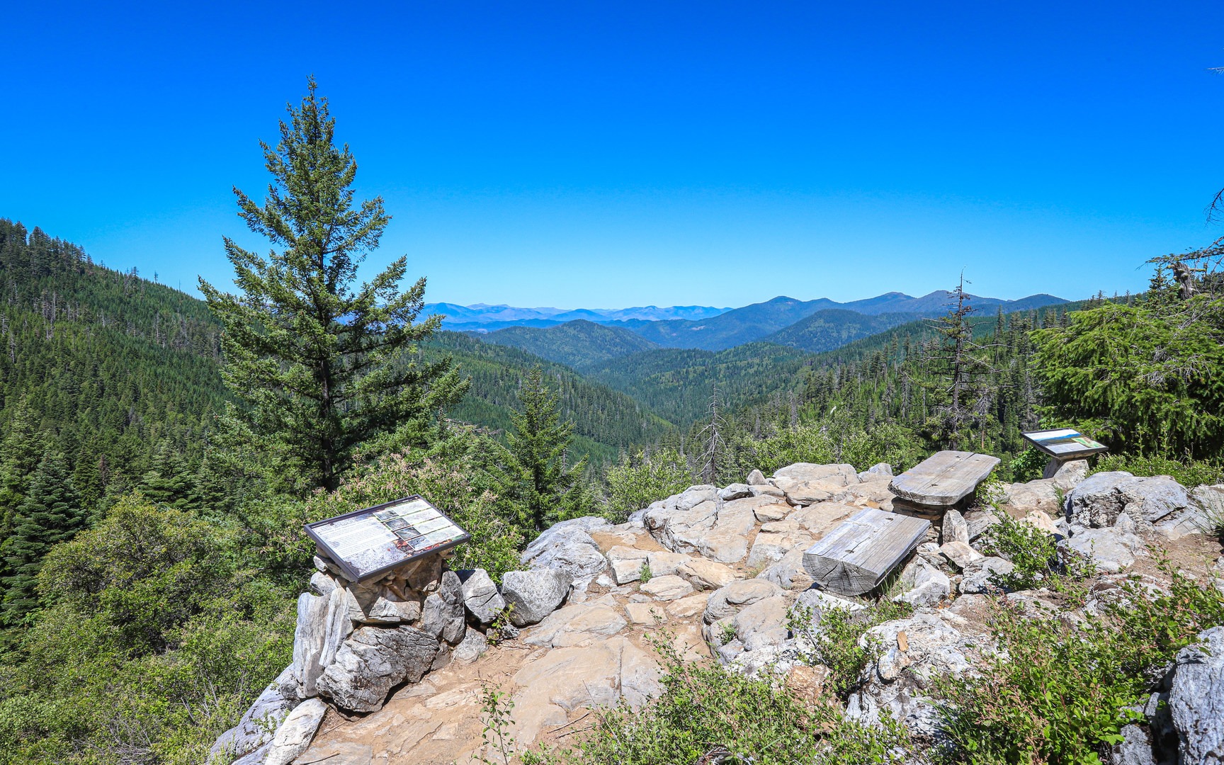 Leaving the forest, the trail peaks at a wide view across the Illinois Valley.