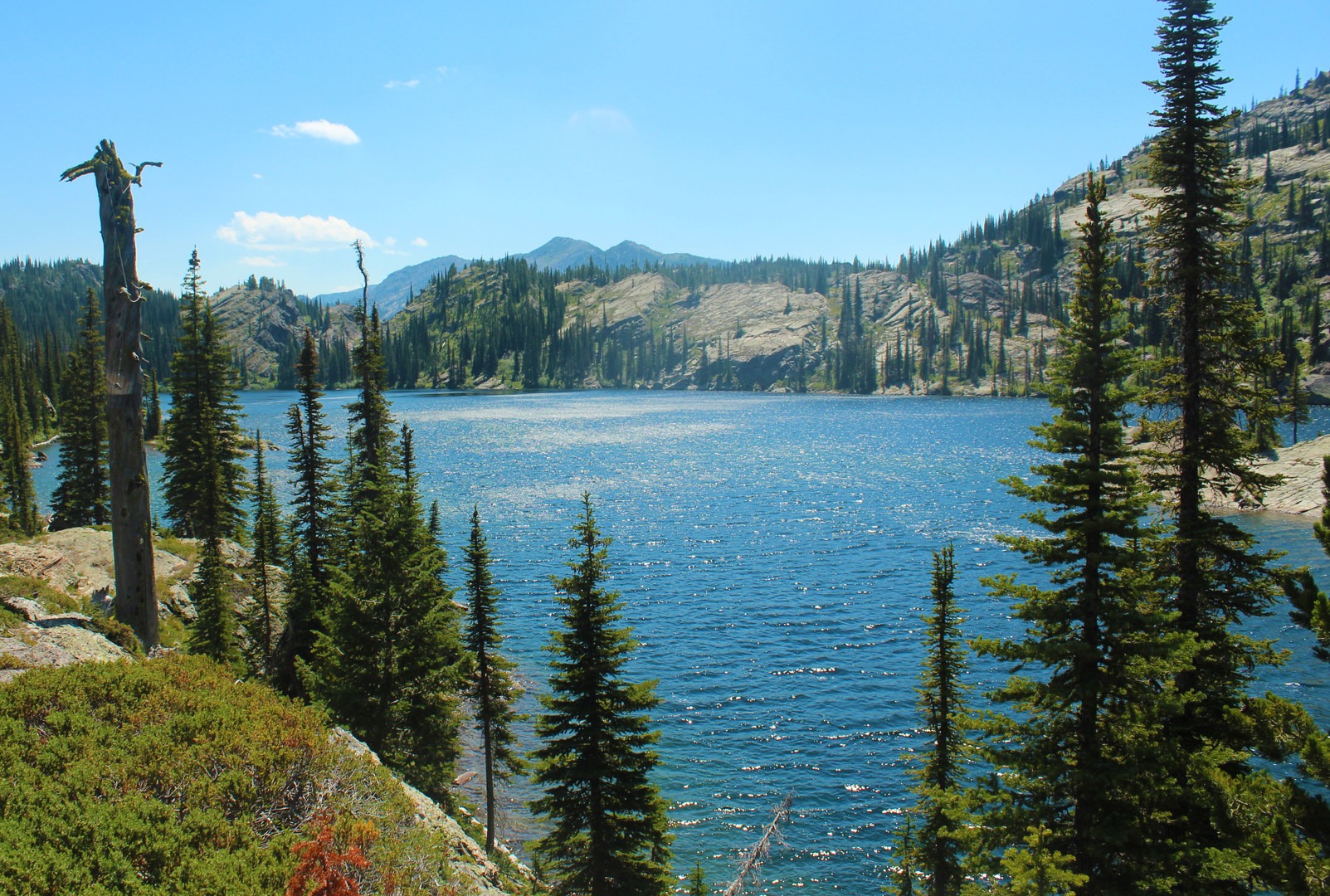 Crater Lake is so named because it is one of the deepest alpine lakes in the Jewel Basin range of the Swan Mountains. The large granite slabs all around it form a sort of bowl on all sides of the lake.