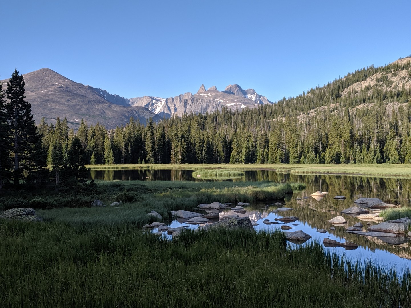 Cloud Peak and the sawtooth ridge formed by Black Tooth and Woolsey peaks viewed from Lake Winnie.