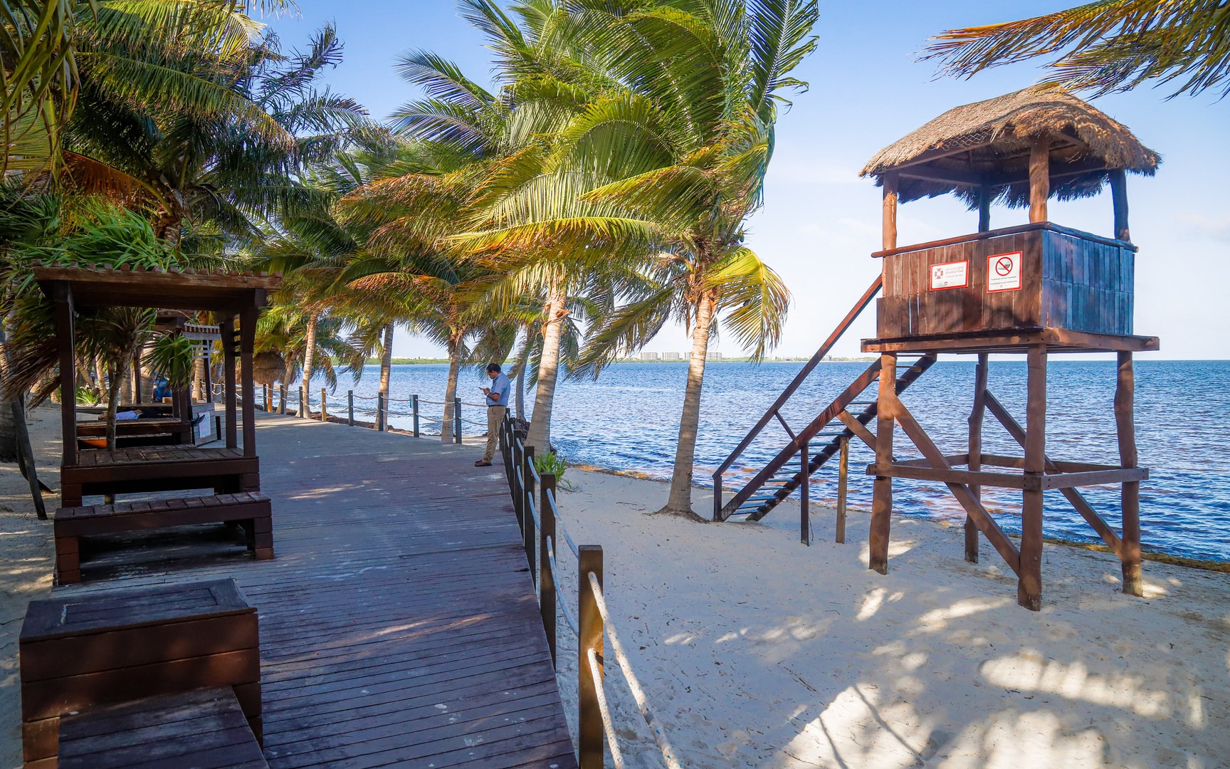 Covered picnic tables and an observation tower along the beach.