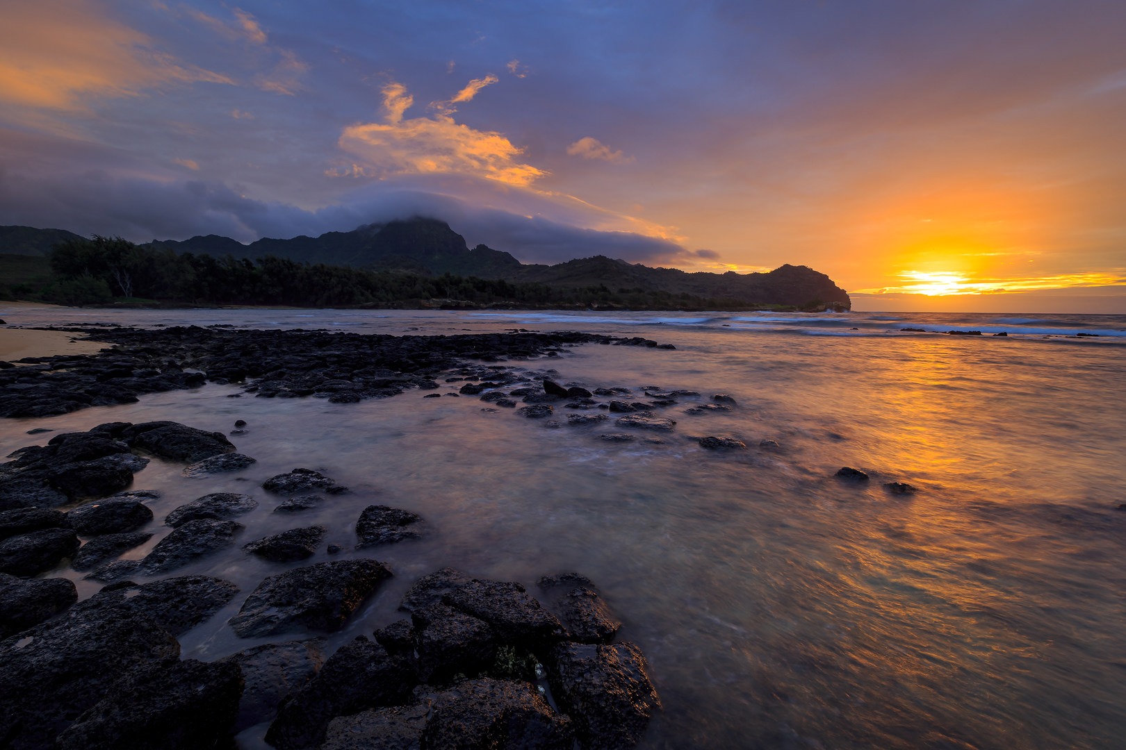 Morning light over Gillins Beach's east cove and Haupu.