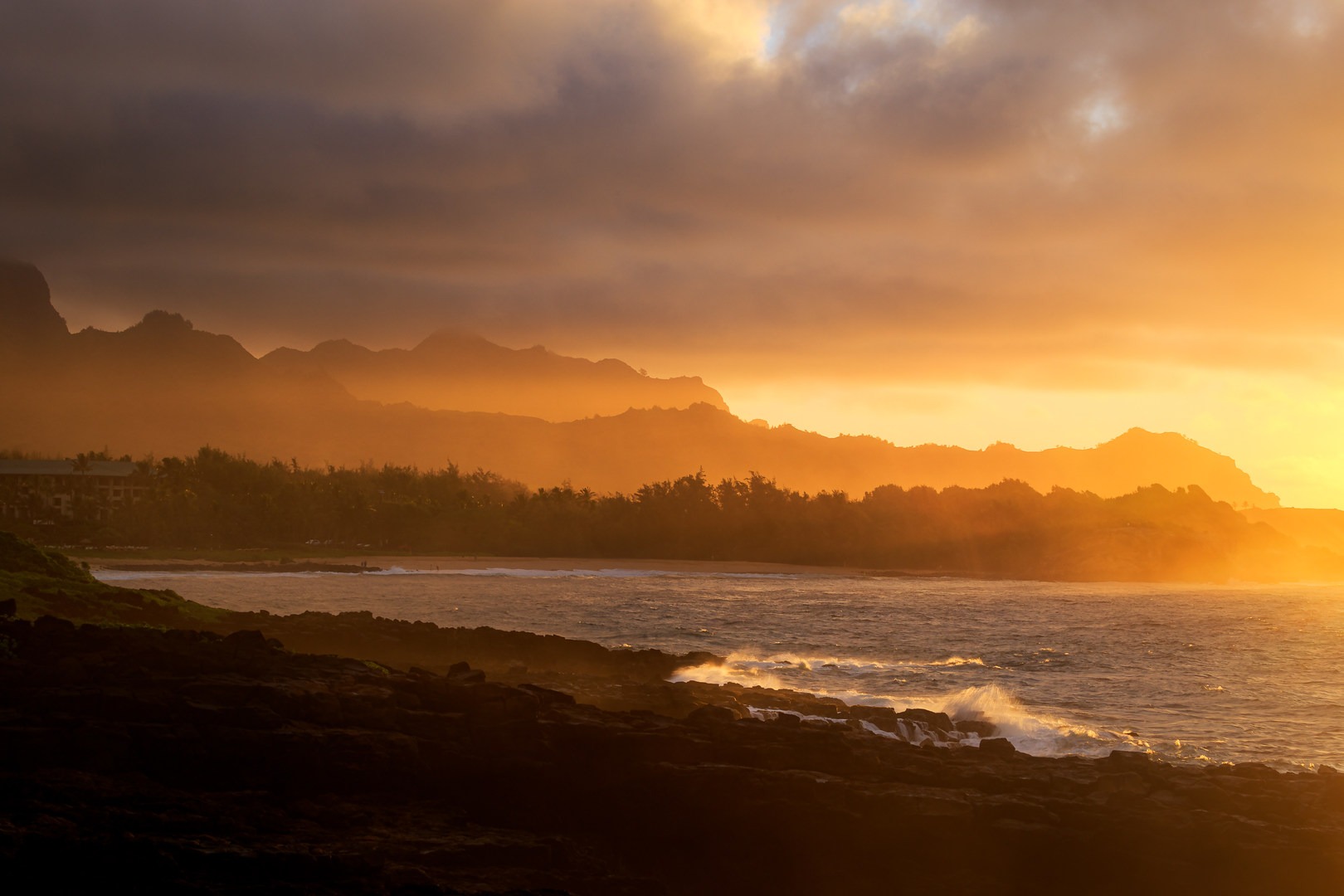 Early morning light cuts through the sea mist as clouds sweep over Haupu.