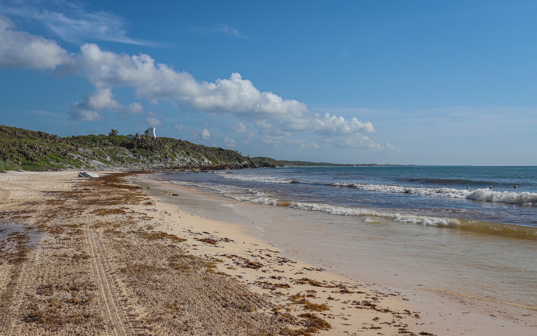 Looking to the north affords views of the Tulum cliffs, with the archaeological site visible in the distance.