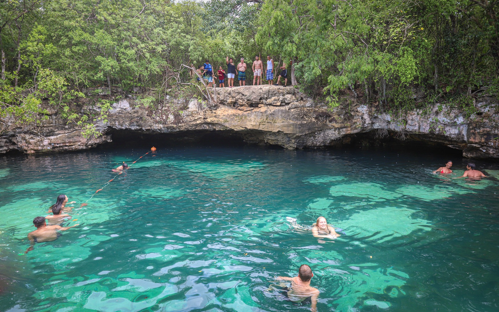 The cenote offers a ledge where visitors can jump into the waters below.