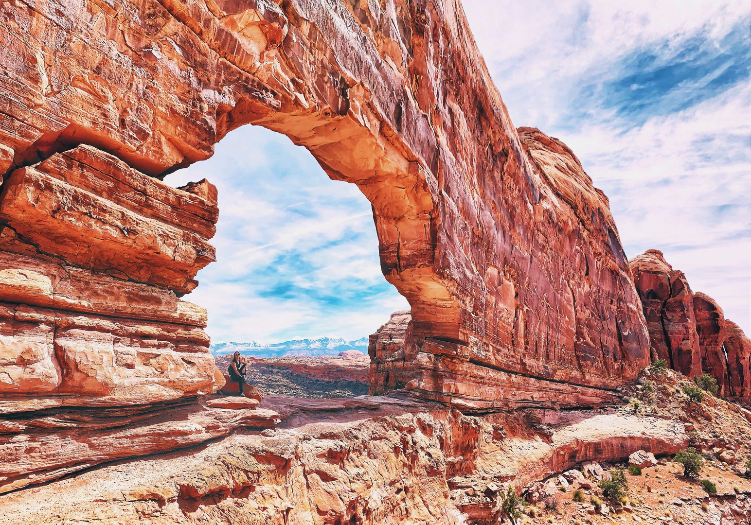 Jeep Arch is the lone arch eroded into a massive sandstone wall formation.
