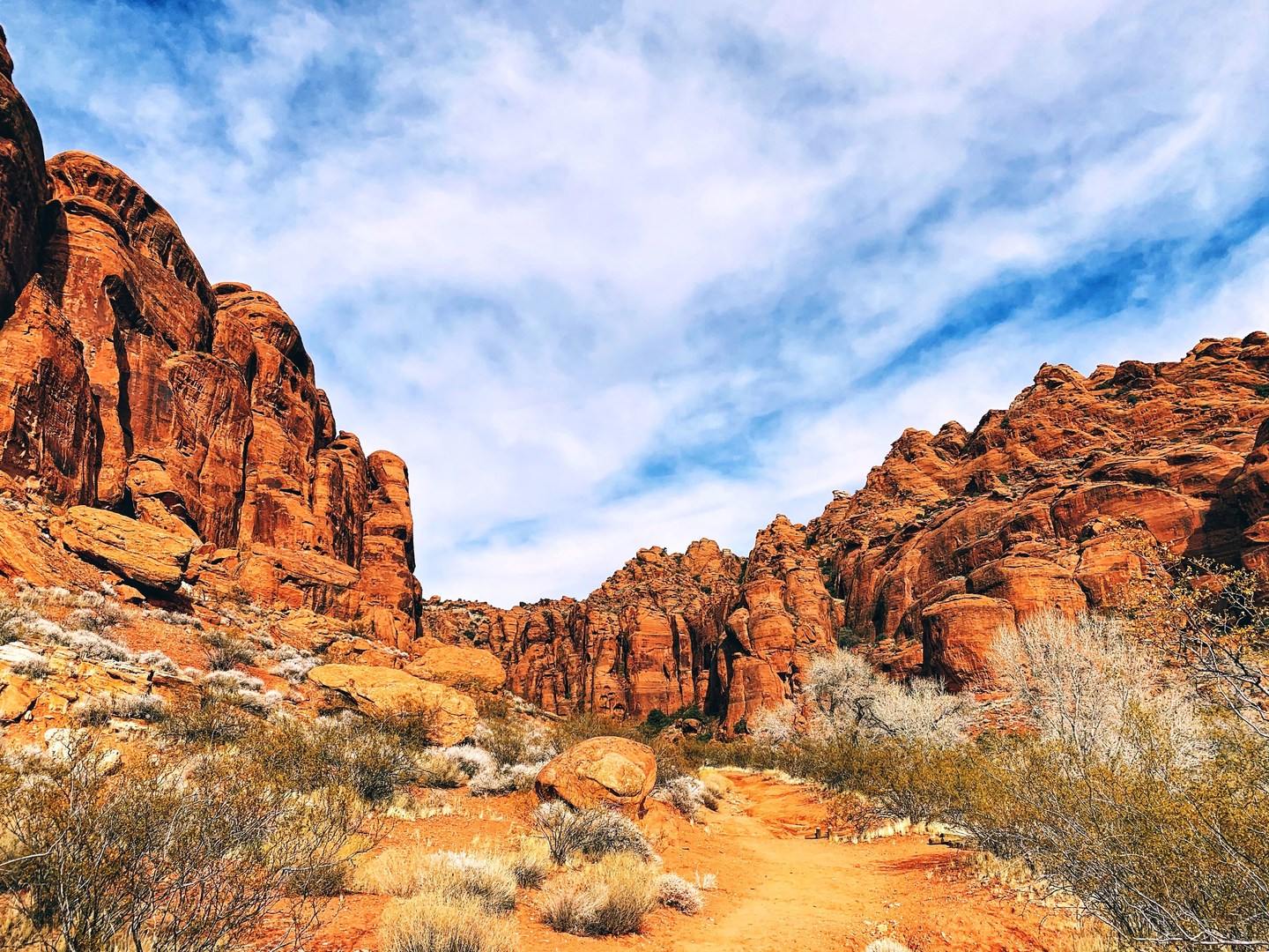 Hiking through the Kayenta Wash is a low-impact and rewarding experience with stellar views of the red walls of your destination in the distance.