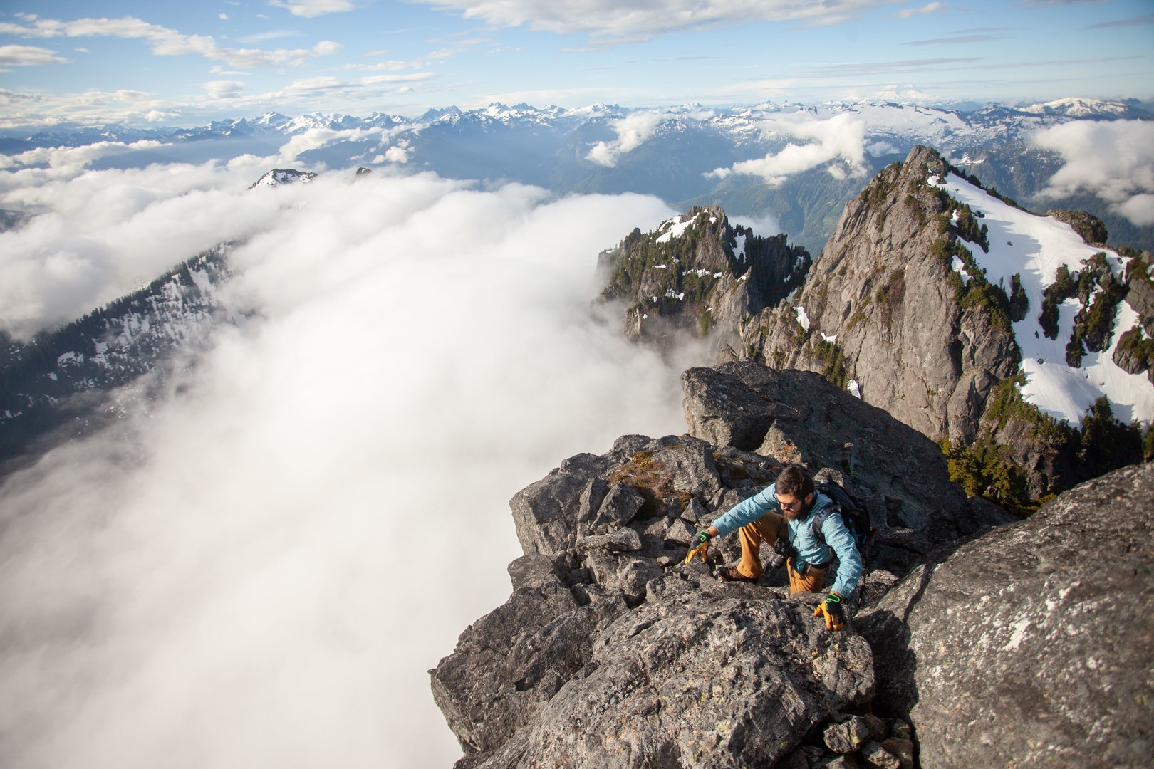Climbing up the summit ridge with Rainier in the background (straight above the climber).