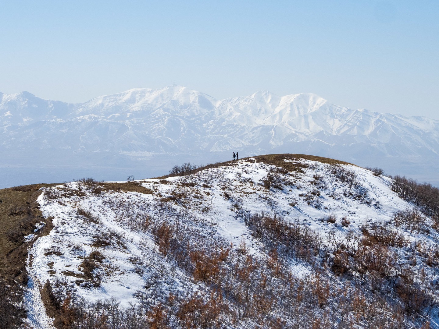 Two hikers on a nearby trail as seen on the descent from Twin Peaks.