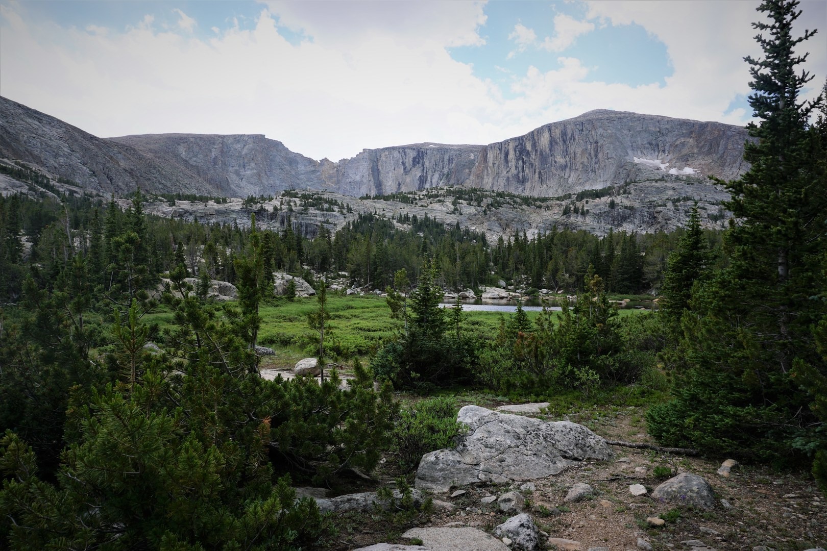 As you get closer, you'll start to see some ponds and small, unnamed lakes below Leg Lake, which lies right at the base of those distant walls.