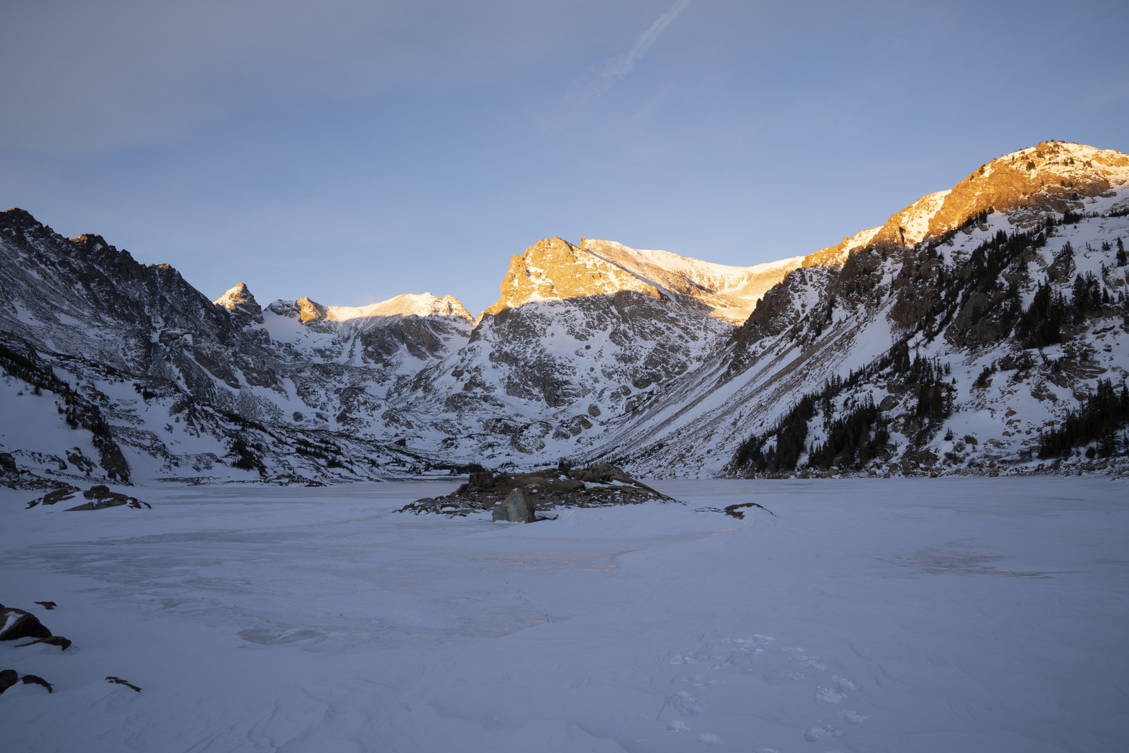 Lake Isabelle and the surrounding mountains just after sunrise.