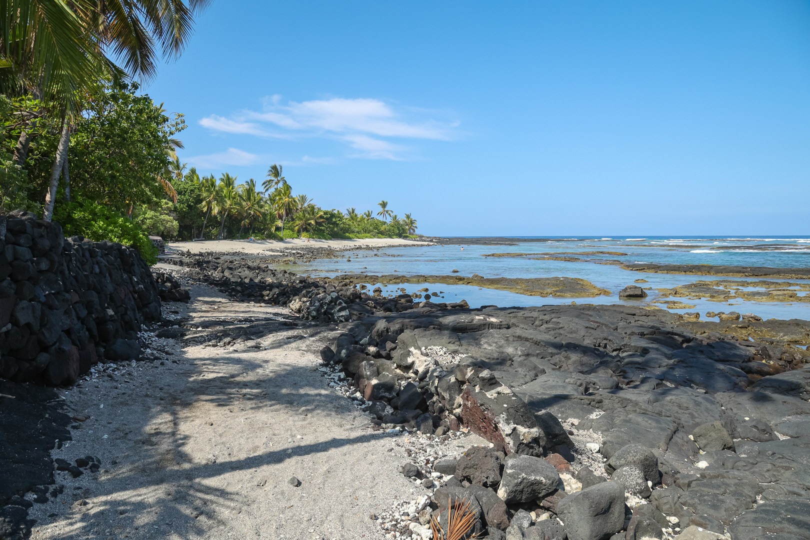 Shallow sandy pools lie along the shore of the beach, perfect for children.