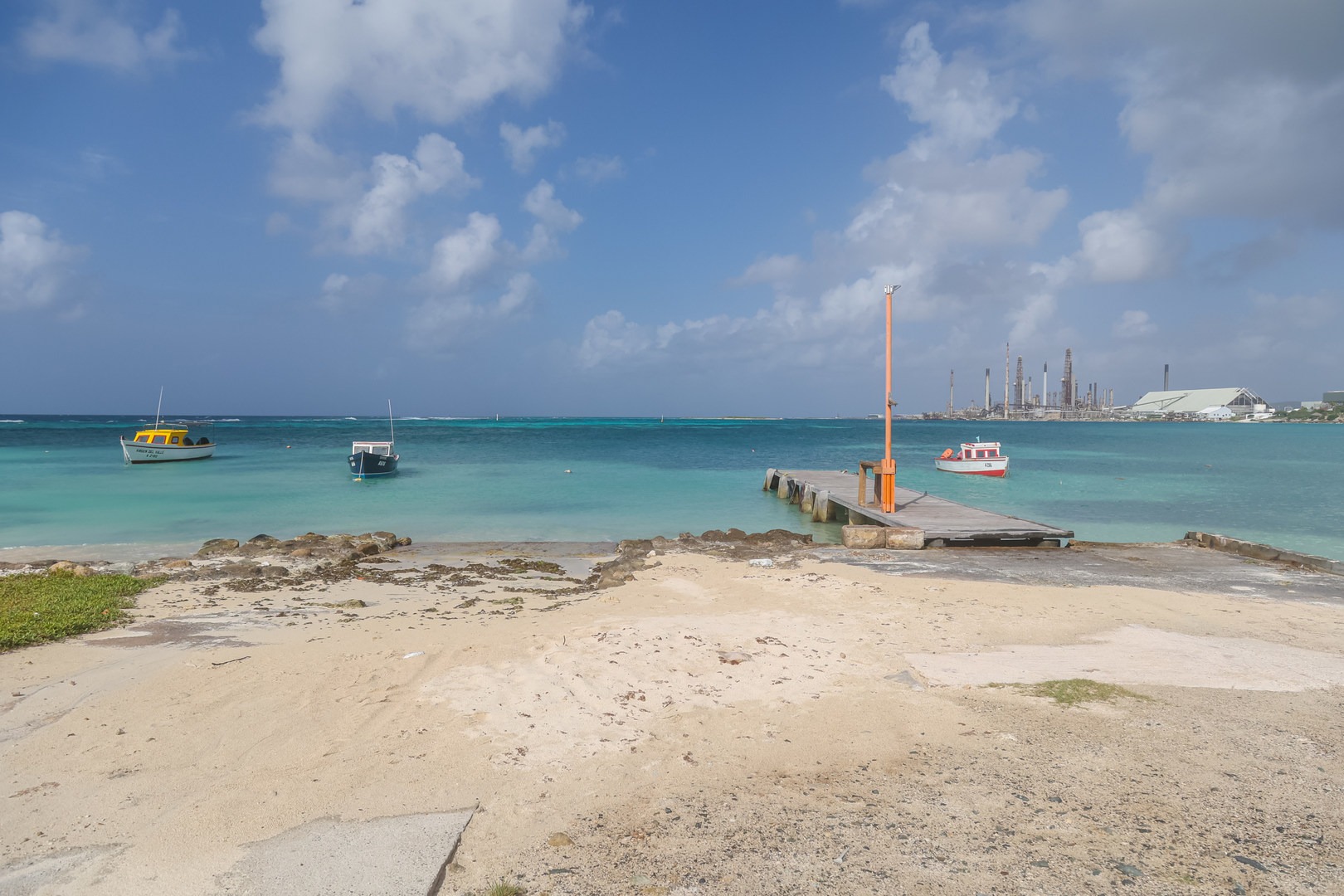A few fishing boats moored along the beach's eastern end create of picturesque view.