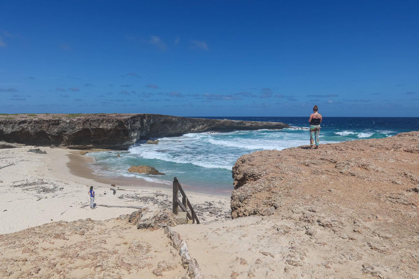Wooden stairs to Boca Prins white sand beach.