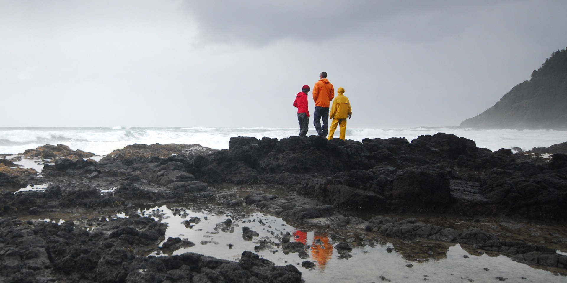 Storm watchers out on the basalt at Thor's Well + Cook's Chasm, Oregon.